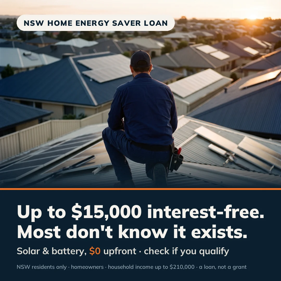 Solar installer seen from behind on a rooftop looking out over Australian suburban rooftops at sunrise