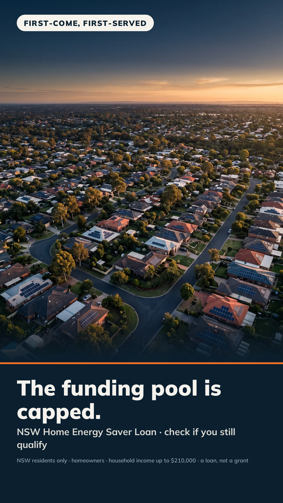 Aerial view over an Australian suburb at dusk with solar panels across many rooftops